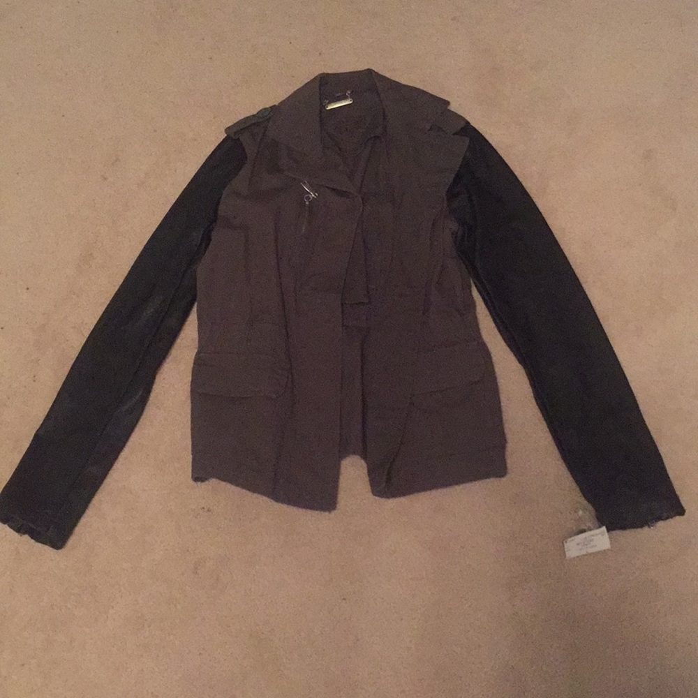An army color jacket with black shimmery sleeves.